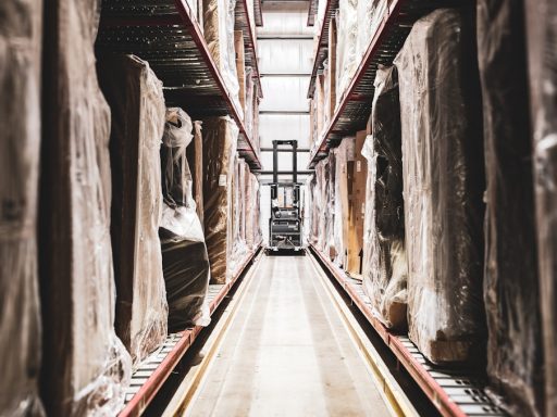 A train track in a large building with statues on it