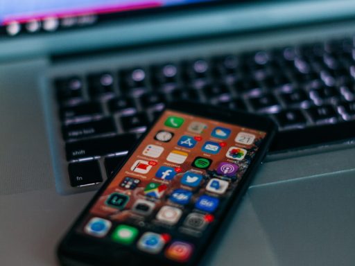 selective focus photography of iPhone on MacBook