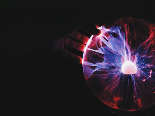 human hand holding plasma ball