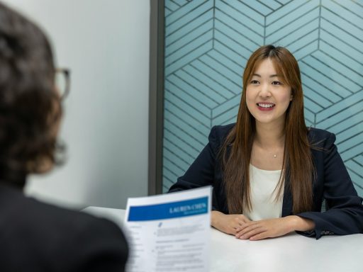 a woman sitting at a table with a piece of paper in front of her