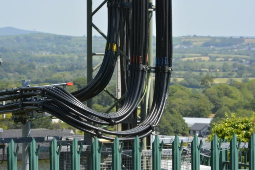 black metal frame near green and white building during daytime