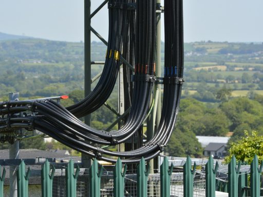 black metal frame near green and white building during daytime