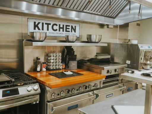 a kitchen with stainless steel appliances and a wooden counter