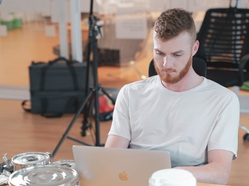 a man sitting at a table with a laptop