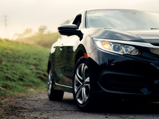 black mercedes benz c class on dirt road during daytime