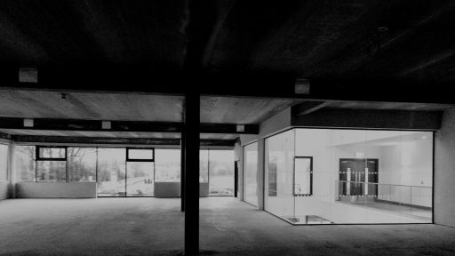 Modern interior space with glass walls and concrete beams