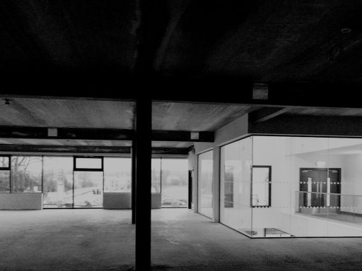 Modern interior space with glass walls and concrete beams