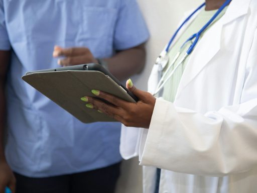 a doctor showing a patient something on the tablet