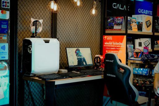 a computer desk with a monitor and a laptop on it
