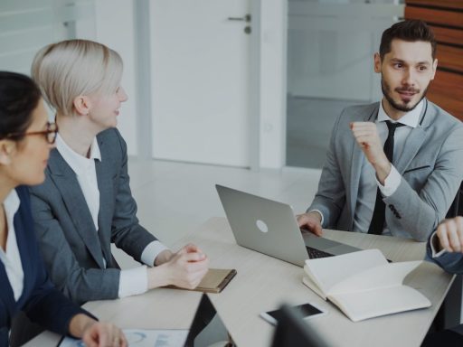 Four professionals in a business meeting around a table