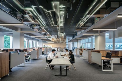 three people collaborating in open office