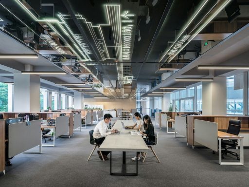 three people collaborating in open office