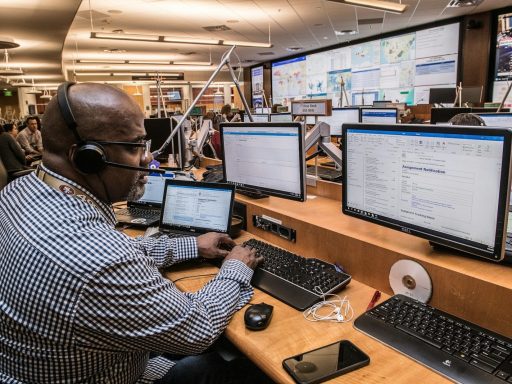 man in black and white checkered dress shirt using computer