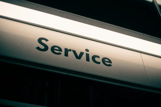 A sign with the word Service in black letters on a white background