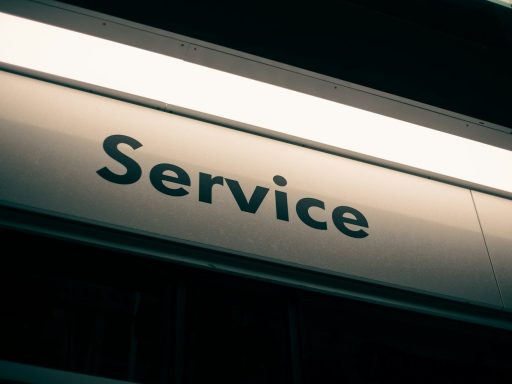 A sign with the word Service in black letters on a white background
